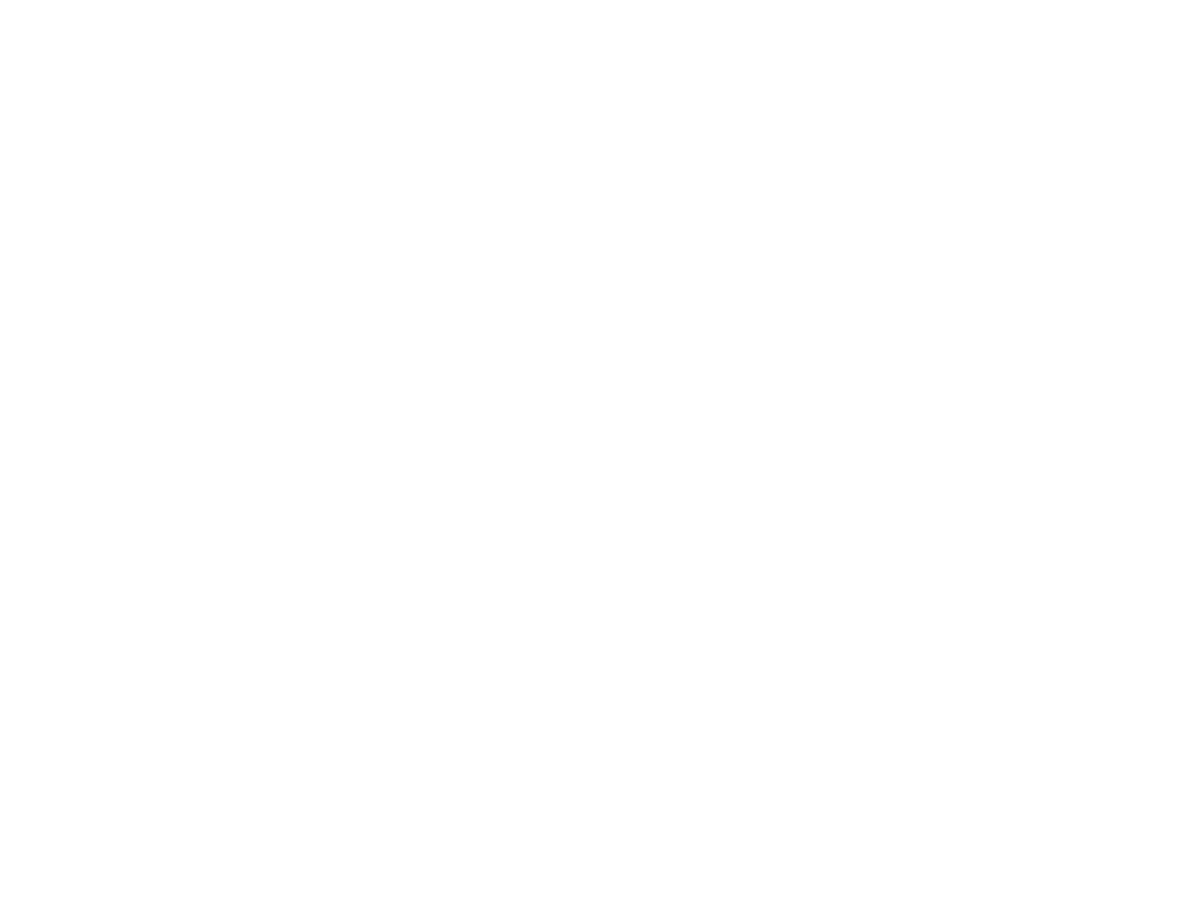 Portrait of a man with brown hair and glasses on a flat gray background.